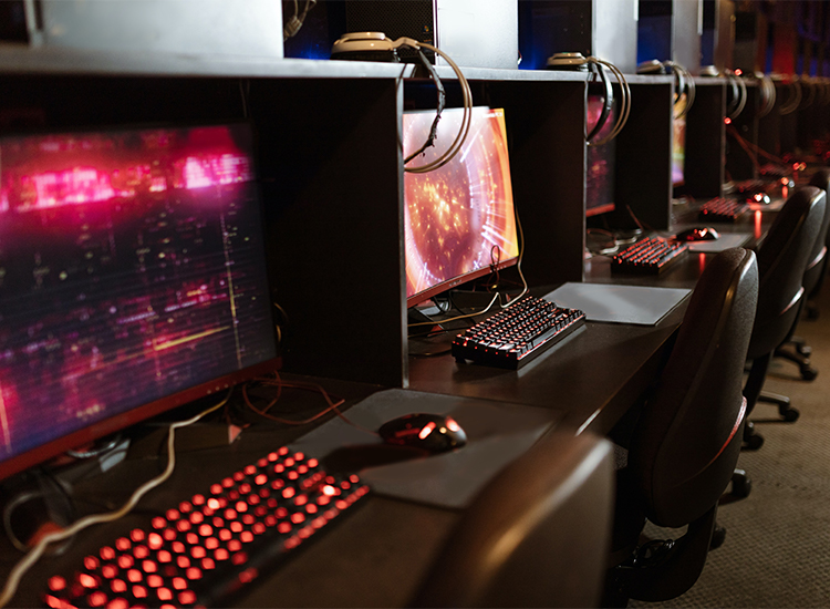 A row of computers glowing in a fluorescent red hue
